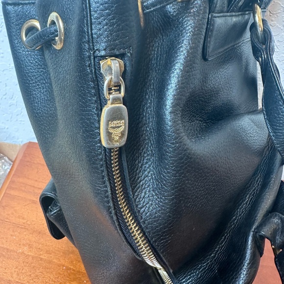 MCM Black Leather Drawstring Shoulder Backpack with Gold Accents - Picture 8 of 11